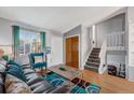 Bright living room with hardwood floors, comfortable seating, and plenty of natural light at 16980 E Stanford Ave, Aurora, CO 80015