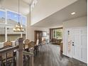Open-concept dining area with large windows and hardwood flooring, with great natural light at 6432 S Robb Ct, Littleton, CO 80127