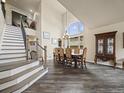 Elegant dining room with high ceilings, a large window, and stylish staircase at 6432 S Robb Ct, Littleton, CO 80127