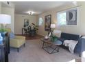 Inviting living room with neutral walls, sleek furniture and ample natural light at 1271 Xapary St, Aurora, CO 80011