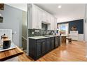 Well-appointed kitchen features sleek cabinets, modern fixtures, and wood flooring at 3109 N Williams St, Denver, CO 80205