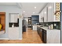 Modern kitchen showcasing sleek countertops, black appliances, and hardwood flooring throughout at 3109 N Williams St, Denver, CO 80205