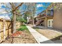 Inviting backyard path leading to townhomes with stairs to outdoor decks on a sunny day at 5300 E Cherry Creek South Dr # 124, Denver, CO 80246