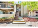 Multi-level condo exterior with stairs leading to upper units and patios surrounded by greenery at 5300 E Cherry Creek South Dr # 124, Denver, CO 80246