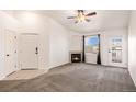 Cozy living room featuring a fireplace, ceiling fan and large window for ample natural light at 5756 N Genoa Way # 12-305, Aurora, CO 80019