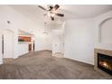 Open living room featuring a fireplace and adjoined to the kitchen area at 5756 N Genoa Way # 12-305, Aurora, CO 80019