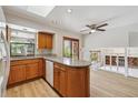 Bright eat-in kitchen featuring wooden cabinets, granite counters, a window over the sink, and access to the living area at 6247 S Locust St, Centennial, CO 80111