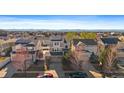Wide aerial shot of home showcasing solar panels and neighborhood, with mountain backdrop at 4787 Dunkirk St, Denver, CO 80249