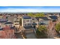 Aerial view of the home with solar panels and mountain views in the background at 4787 Dunkirk St, Denver, CO 80249
