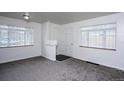 Neutral living room featuring plush gray carpet and natural light at 482 N Humboldt St, Denver, CO 80218