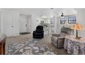 Living room and kitchen with white cabinets and bar seating at 10950 W Florida Ave # 303, Lakewood, CO 80232