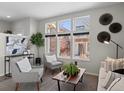 Bright living room with large windows, comfortable seating, and stylish decor, creating a cozy atmosphere at 1996 W 66Th Ave, Denver, CO 80221