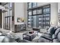 Modern living room boasts large windows, a comfortable sofa, and industrial chic decor at 3100 Huron St # 4Q, Denver, CO 80202