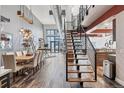Bright living space featuring open floor plan, hardwood floors, and modern staircase at 3100 Huron St # 4Q, Denver, CO 80202