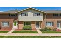Charming brick townhome with a well-maintained front yard and a welcoming entrance at 9263 E Nassau Ave, Denver, CO 80237
