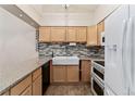 Kitchen featuring granite countertops, farmhouse sink, stainless faucet and modern appliances at 4195 W 111Th Cir, Westminster, CO 80031