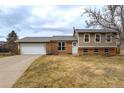 Charming two-story home with a well-maintained front yard and attached two-car garage at 4653 S Yank St, Morrison, CO 80465