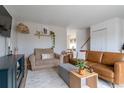 Cozy living room with stylish furnishings, including a comfortable armchair and leather sofa at 4653 S Yank St, Morrison, CO 80465