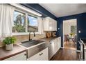 Bright eat-in kitchen with a stainless steel sink, wood floors and stainless steel appliances at 14753 E Alabama Pl, Aurora, CO 80012