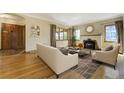 Cozy living room featuring a fireplace, hardwood floors, and ample natural light at 2285 N Monaco Pkwy, Denver, CO 80207