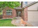 Charming brick home featuring a well-manicured lawn and inviting entrance at 7420 S Houstoun Waring Cir, Littleton, CO 80120