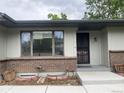 Close-up view of a brick home entrance with a metal security door at 4115 S Vincennes Ct, Denver, CO 80237