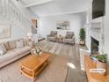 Virtually staged living room featuring a fireplace, neutral decor, and ample natural light at 9010 W 88Th Cir, Westminster, CO 80021