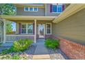 Charming front porch featuring a white railing and purple shutters, creating a welcoming entrance to this lovely home at 16500 Hitching Post Cir, Parker, CO 80134