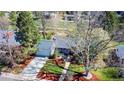 Aerial view of a well-maintained home featuring lush landscaping, mature trees, and an inviting front entrance at 2261 W Briarwood Ave, Littleton, CO 80120