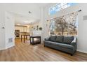 Spacious living room with fireplace, wood floors, and large windows showcasing the outdoor view at 7453 S Norfolk St, Aurora, CO 80016