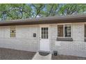 Charming home exterior featuring a white door and a well-maintained gray brick wall at 2955 N Gilpin St, Denver, CO 80205