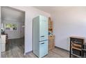 Kitchen area featuring a retro style refrigerator, wood cabinet, and adjacent view of the living area at 2955 N Gilpin St, Denver, CO 80205