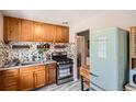 Charming kitchen featuring wood cabinets, stainless steel appliances, and a vintage-style refrigerator at 2955 N Gilpin St, Denver, CO 80205