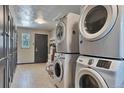 Functional laundry room with multiple washing machines, dryers, and ample storage space at 2955 N Gilpin St, Denver, CO 80205