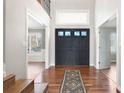 Inviting foyer featuring hardwood floors, a decorative rug, and a view into adjacent living spaces at 2451 S Fenton Dr, Lakewood, CO 80227