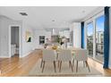 Dining area open to the kitchen with hardwood floors and balcony access at 1284 Tennyson St # 1, Denver, CO 80204