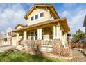 Two-story house with a wrap-around porch and stone accents at 8445 Braun Loop, Arvada, CO 80005