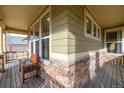 Front porch with stone and wood details, and a bench at 8445 Braun Loop, Arvada, CO 80005