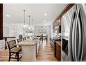 Open-concept kitchen featuring a large island with granite countertops and stainless steel appliances at 4400 S Ensenada St, Aurora, CO 80015