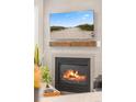 Close-up of the living room fireplace and mantle with a view of the beach on the TV at 2528 Concord Cir, Lafayette, CO 80026