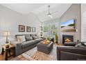 Bright living room with cathedral ceilings, cozy fireplace, and large windows that provide lots of natural light at 2528 Concord Cir, Lafayette, CO 80026
