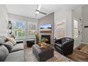 Stylish living room with fireplace, comfortable seating, and large windows flooding the space with natural light at 2528 Concord Cir, Lafayette, CO 80026