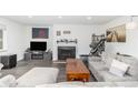 Comfortable living room with fireplace, TV, and large sectional sofa at 4663 S Lowell Blvd, Denver, CO 80236