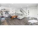 Spacious living room featuring hardwood floors, a staircase, and an abundance of natural light at 4663 S Lowell Blvd, Denver, CO 80236