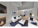 Cozy living room with fireplace, complemented by stylish seating and adjacent dining area at 11101 E Alameda Ave # 202, Aurora, CO 80012