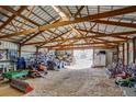 Spacious barn interior with high ceilings, rafters, and ample storage space at 16491 County Road 32, Platteville, CO 80651