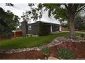 Beautiful home with brick exterior, landscaped front yard with rock garden and mature trees at 5585 W 51St Pl, Denver, CO 80212