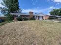 Charming brick home with a covered front porch and spacious front yard at 12063 E Arizona Dr, Aurora, CO 80012