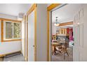 Cozy dining area with a fireplace, wood beams, and a view of the trees at 805 Columbine Rd # 202, Breckenridge, CO 80424