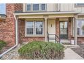 Close-up of a townhouse entrance featuring brick accents, a cozy porch, and clear unit number at 9618 W Chatfield Ave # B, Littleton, CO 80128